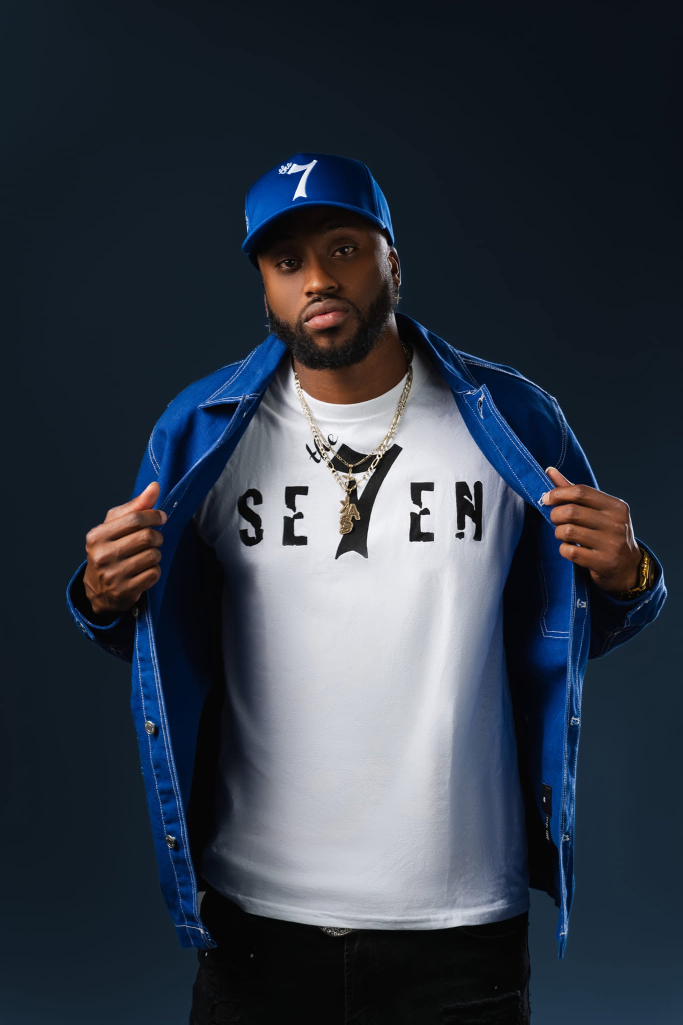 JayDubb Tha Ruler wearing a blue jacket and The 7 shirt